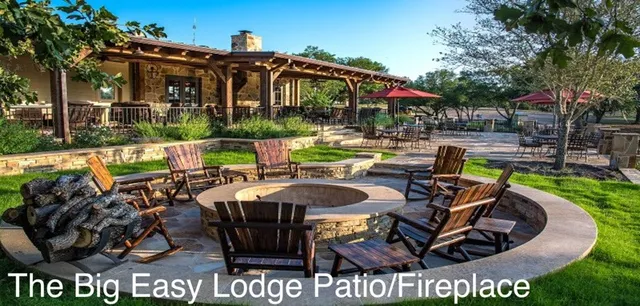 a view of a chairs and table in patio with a fire pit and a fire pit