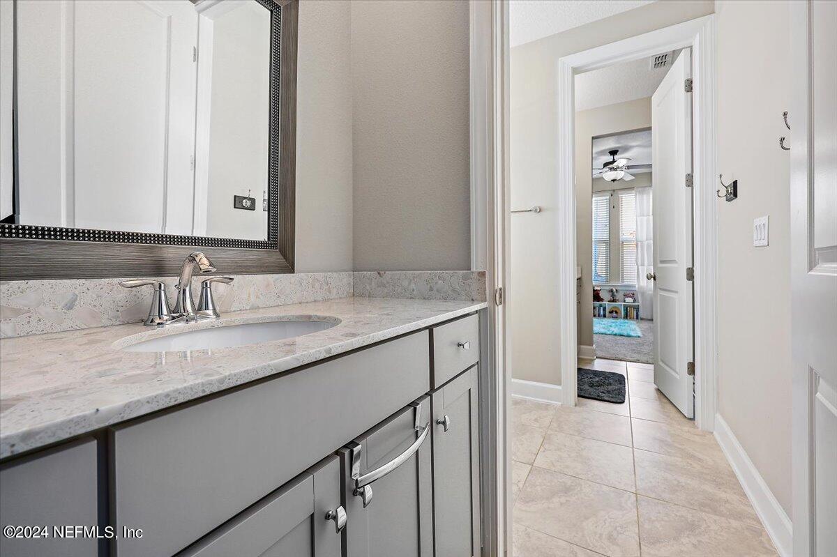 778 Glenneyre Circle St. Augustine, FL 32092 - Photo 19 of 40 a bathroom with a granite countertop sink a toilet and shower