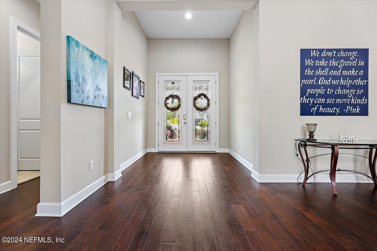 778 Glenneyre Circle St. Augustine, FL 32092 - Photo 2 of 40 a view of an empty room with window and wooden floor