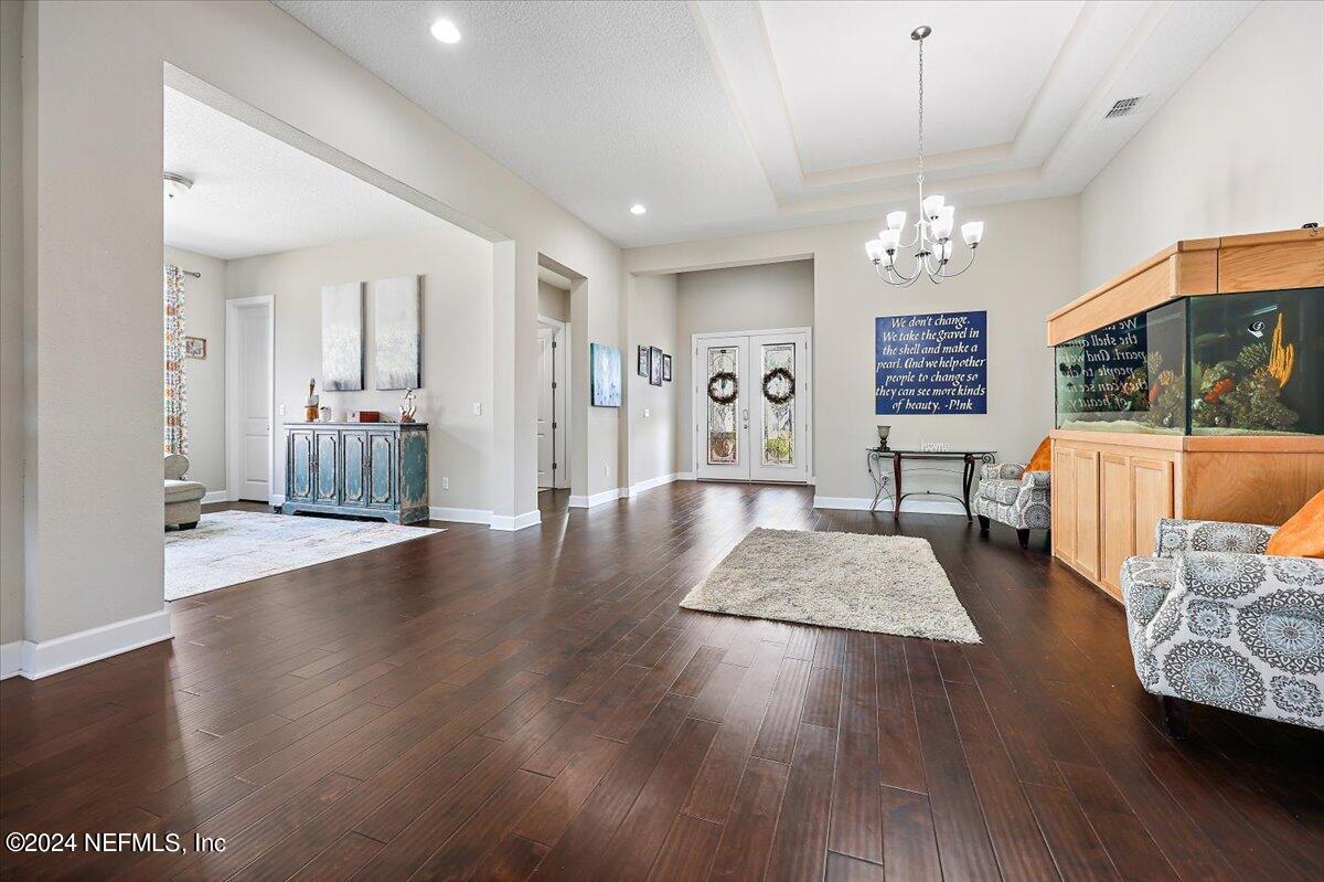 778 Glenneyre Circle St. Augustine, FL 32092 - Photo 4 of 40 a living room with furniture and a chandelier