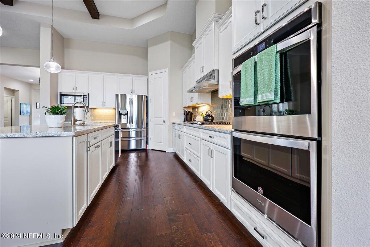 778 Glenneyre Circle St. Augustine, FL 32092 - Photo 9 of 40 a kitchen with stainless steel appliances a stove sink and cabinets