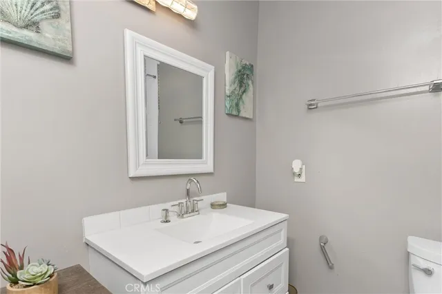 a bathroom with a sink toilet and mirror
