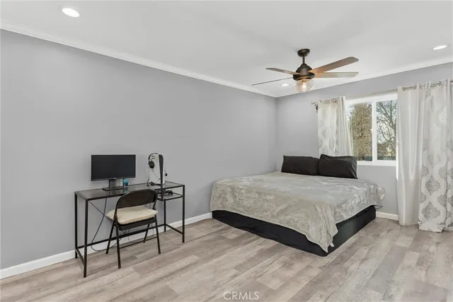 a bedroom with a bed a desk and chair