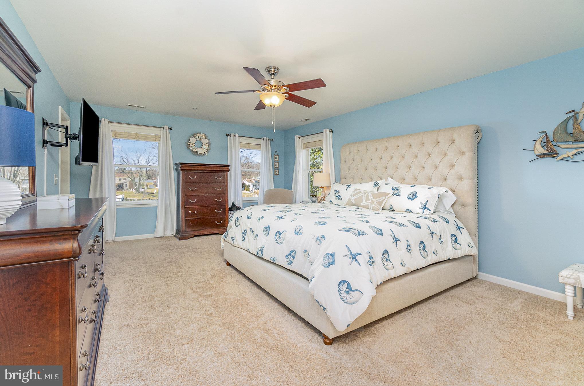 332 Miles Essex, MD 21221 - Photo 11 of 45 a bedroom with a large bed and a chandelier