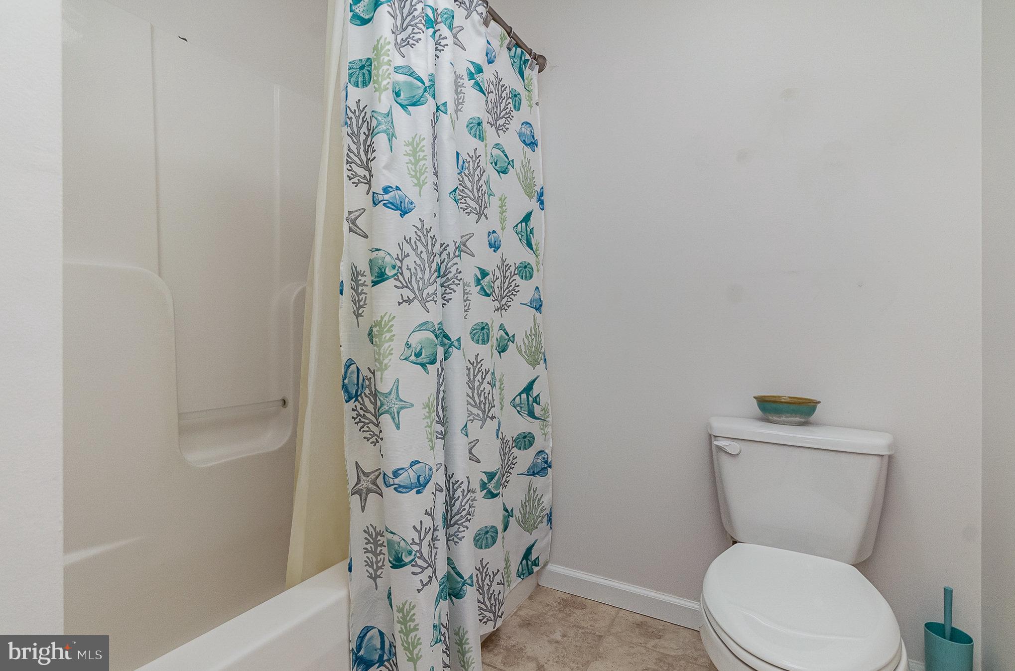 332 Miles Essex, MD 21221 - Photo 20 of 45 a white toilet sitting next to a shower curtain