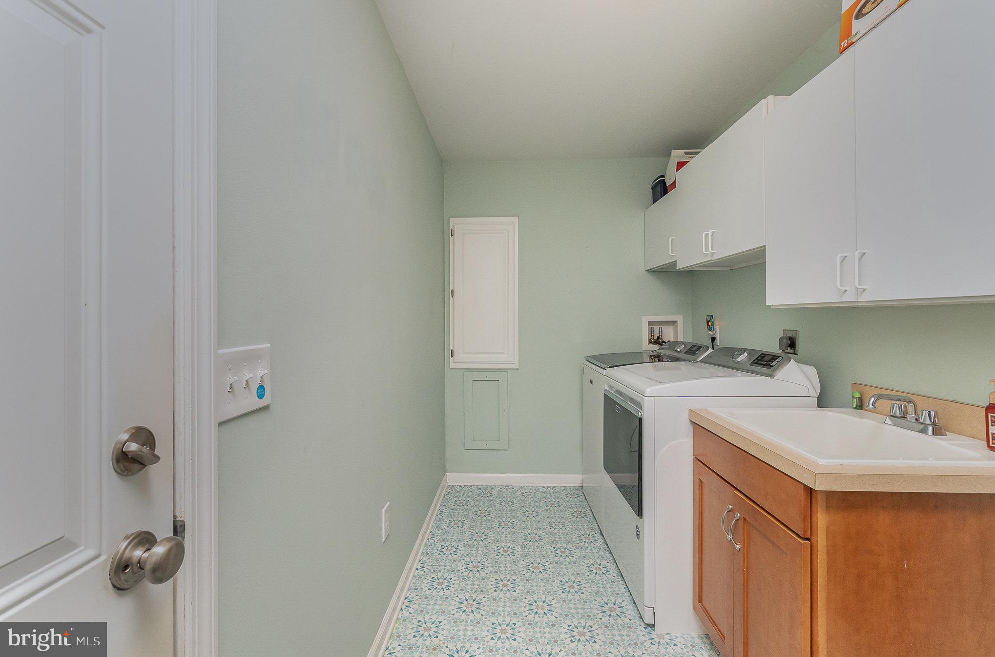 332 Miles Essex, MD 21221 - Photo 31 of 45 a utility room with cabinets washer and dryer