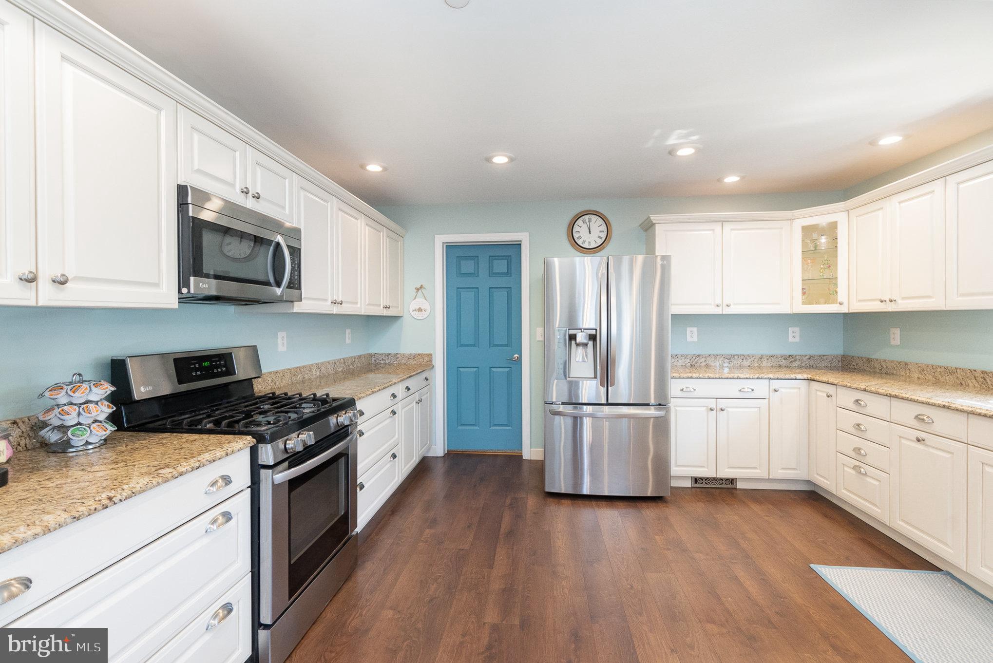 332 Miles Essex, MD 21221 - Photo 9 of 45 a kitchen with granite countertop a stove top oven a sink dishwasher and a refrigerator with wooden floor