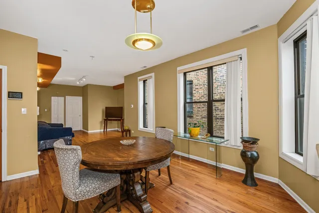 a view of a dining room with furniture and wooden floor