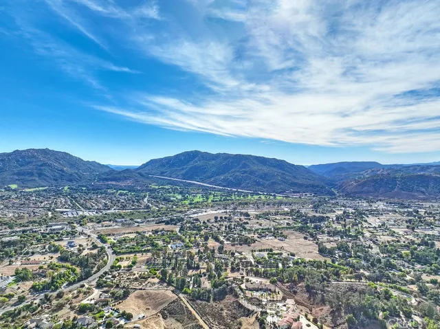 an aerial view of residential building and trees around