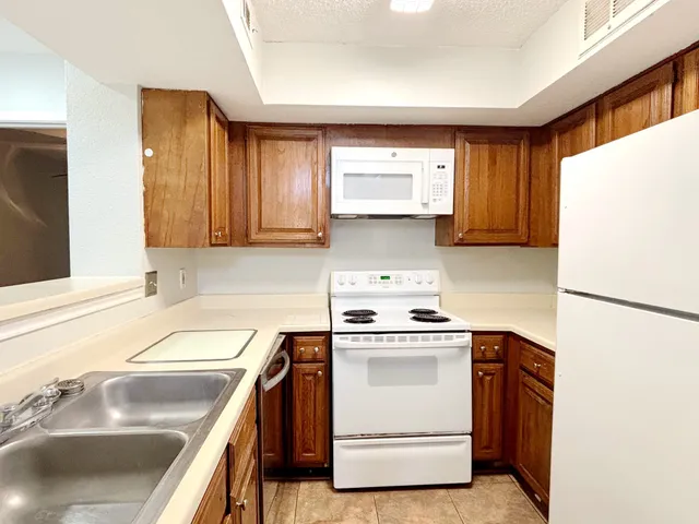 a kitchen with a sink stove and refrigerator