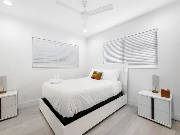 a bedroom with a bed and a lamp