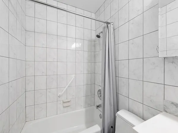 a living room with furniture ceiling fan and a rug