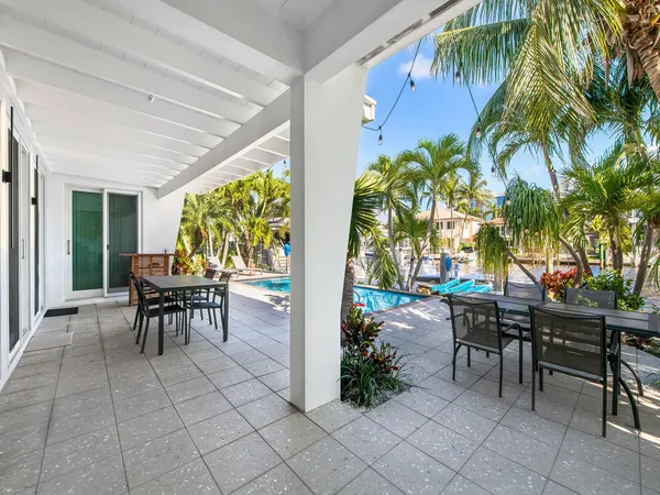 a view of a patio with table and chairs potted plants with wooden floor