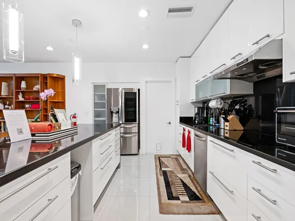 a kitchen with stainless steel appliances kitchen island granite countertop a stove and cabinets