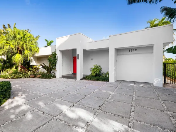 a front view of a house with a yard and a garage