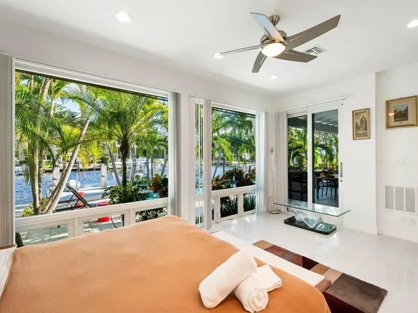 a bedroom with a large bed and a large window