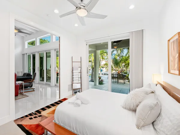 a bedroom with a large bed and a chandelier