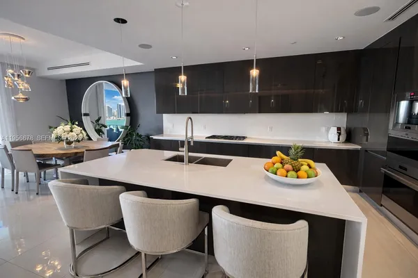 a kitchen with a table and chairs in it