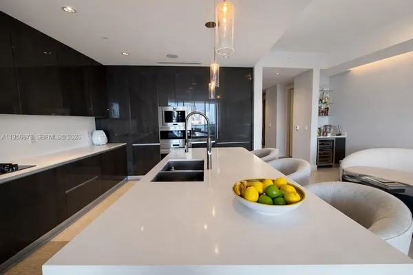 a kitchen with a sink appliances and cabinets