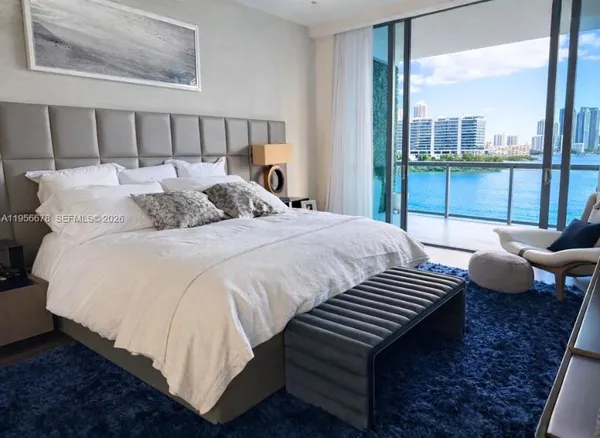 a view of a hallway with wooden floor and a living room