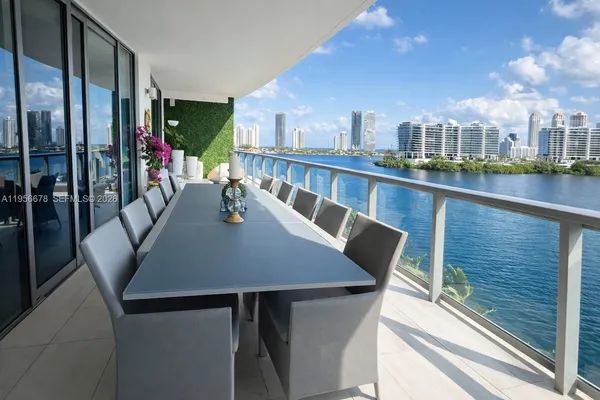 a view of a balcony dining space with furniture