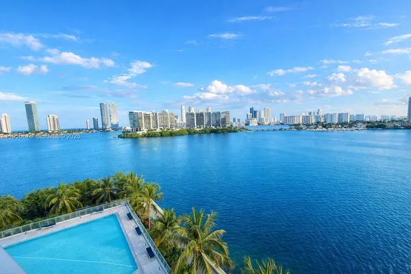a view of a lake with houses in the back