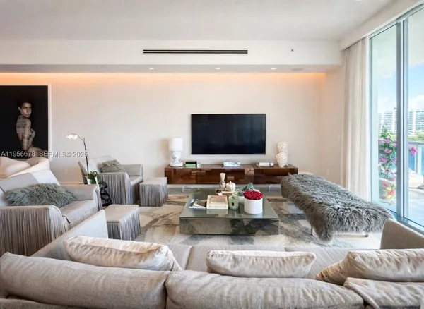 a living room with furniture and a flat screen tv