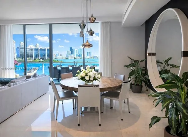 a dining room with furniture a potted plant and chandelier
