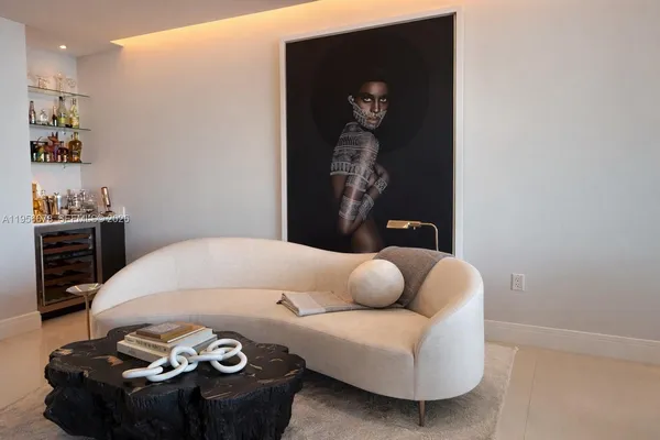 a bedroom with a bed and a wall painting