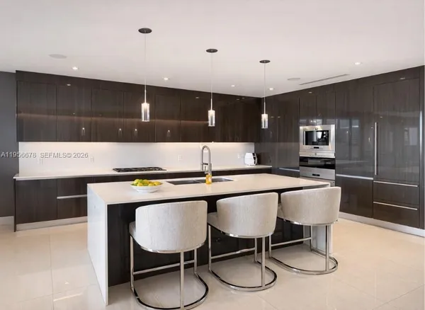 a large kitchen with a table and chairs