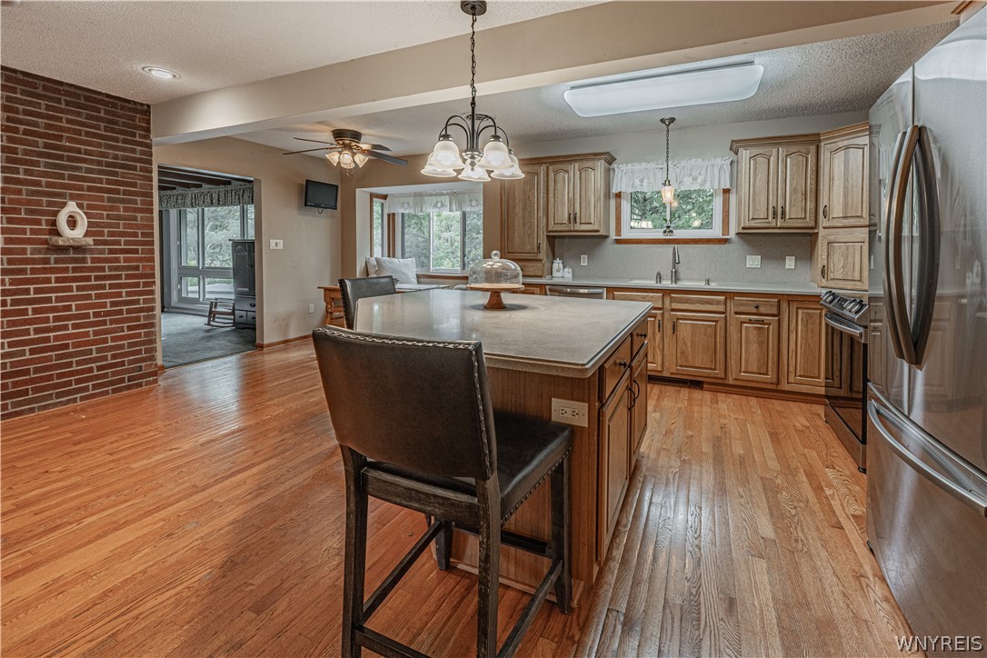 Gleaming hardwood floors and a central island ground this classic oak kitchen space.