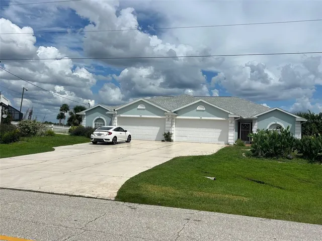 a car parked in front of a house with a yard