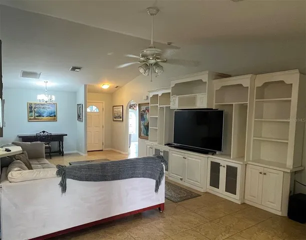 a view of a dining room with furniture and a chandelier
