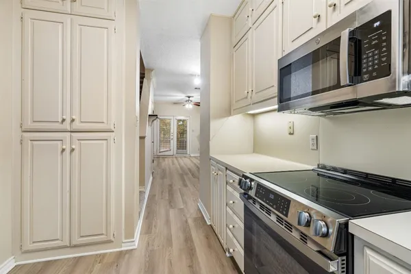 a kitchen with stainless steel appliances granite countertop a stove and a microwave