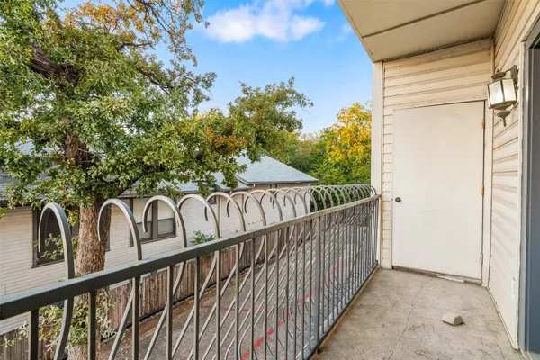 a view of a balcony with wooden fence