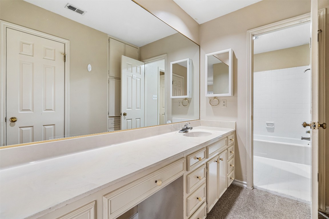 2408 Enfield Road, Unit 211 Austin, TX 78703 - Photo 18 of 26 Full bath with vanity, bathing tub / shower combination, and light carpet