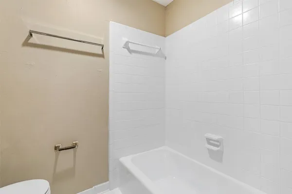 a bathroom with a shower and toilet