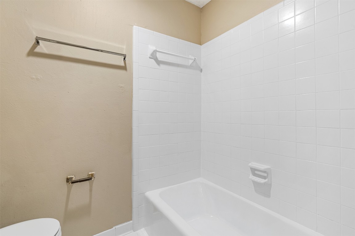 2408 Enfield Road, Unit 211 Austin, TX 78703 - Photo 20 of 26 Bathroom featuring bathtub / shower combination and toilet