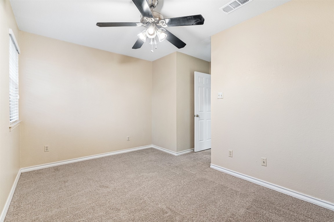 2408 Enfield Road, Unit 211 Austin, TX 78703 - Photo 24 of 26 Unfurnished room with carpet flooring and a ceiling fan