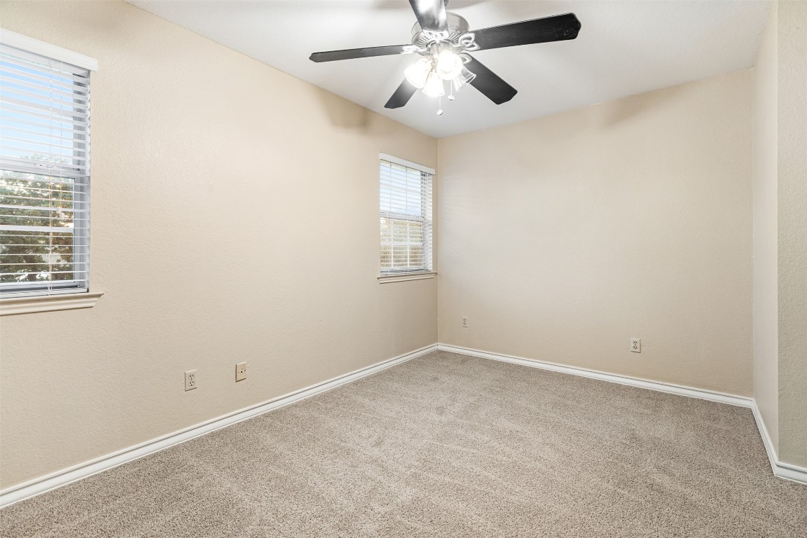 2408 Enfield Road, Unit 211 Austin, TX 78703 - Photo 25 of 26 Empty room featuring carpet flooring and ceiling fan