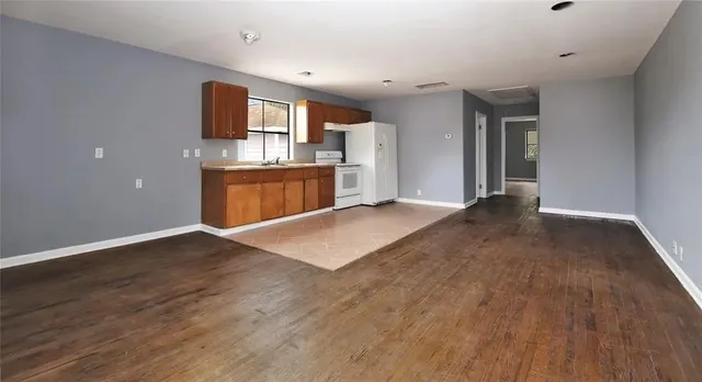 a view of kitchen with refrigerator microwave and stove