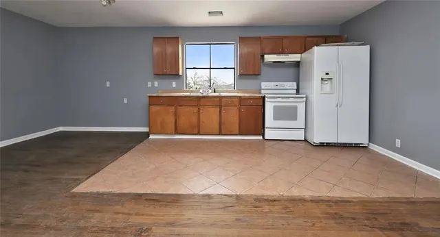 a kitchen with stainless steel appliances granite countertop a refrigerator sink and cabinets