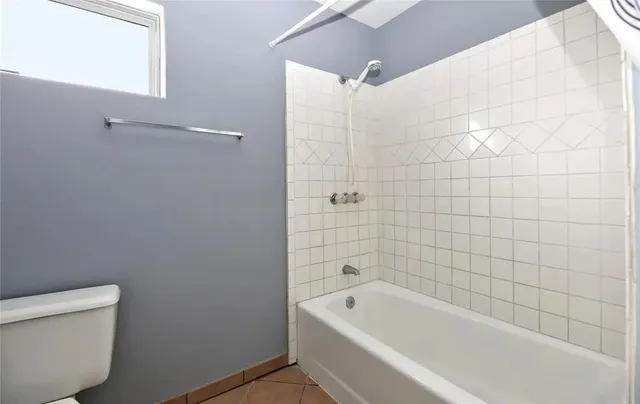 a bathroom with a bathtub and toilet