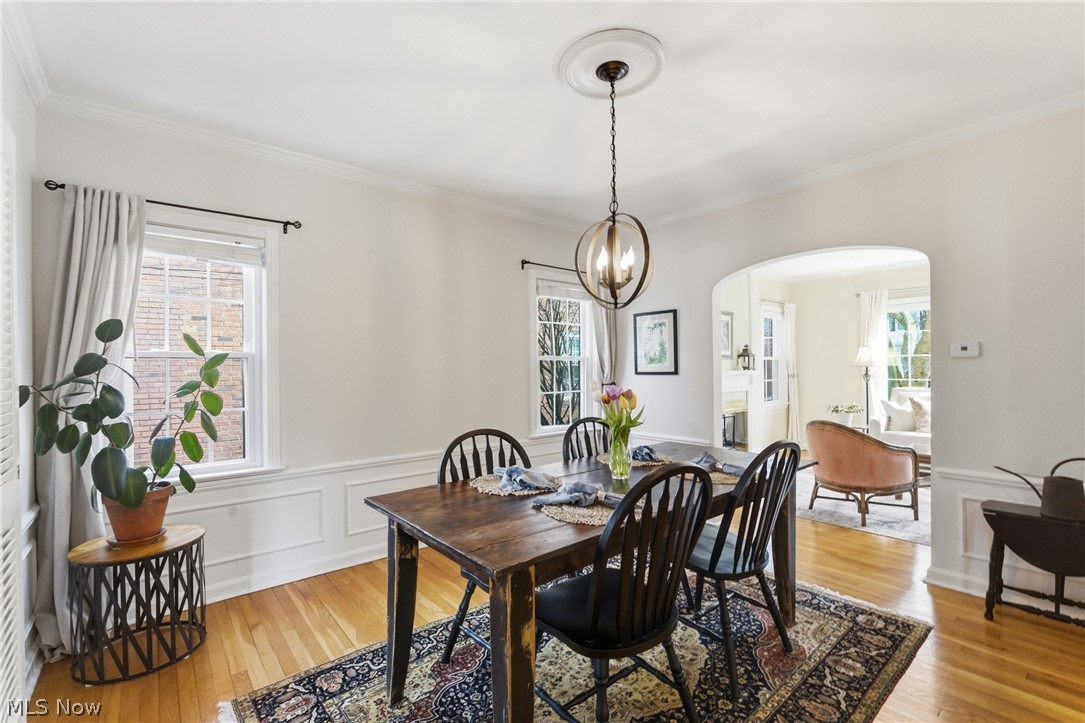 2552 Channing Road Cleveland, OH 44118 - Photo 4 of 33 Dining room featuring arches doorway, crown molding, wainscoting, hardwood floors and chandelier.