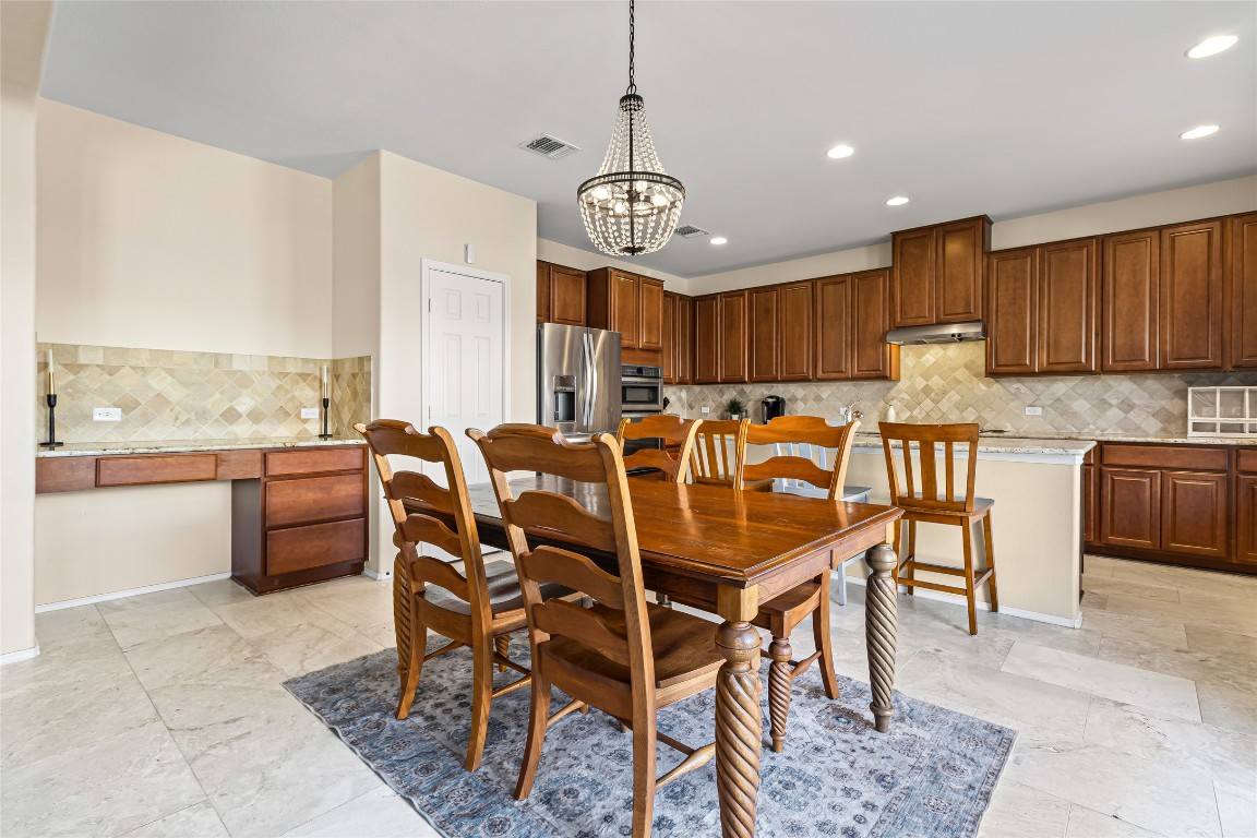 920 Autumn Sage Way Pflugerville, TX 78660 - Photo 18 of 30 a view of a dining room with furniture window and wooden floor