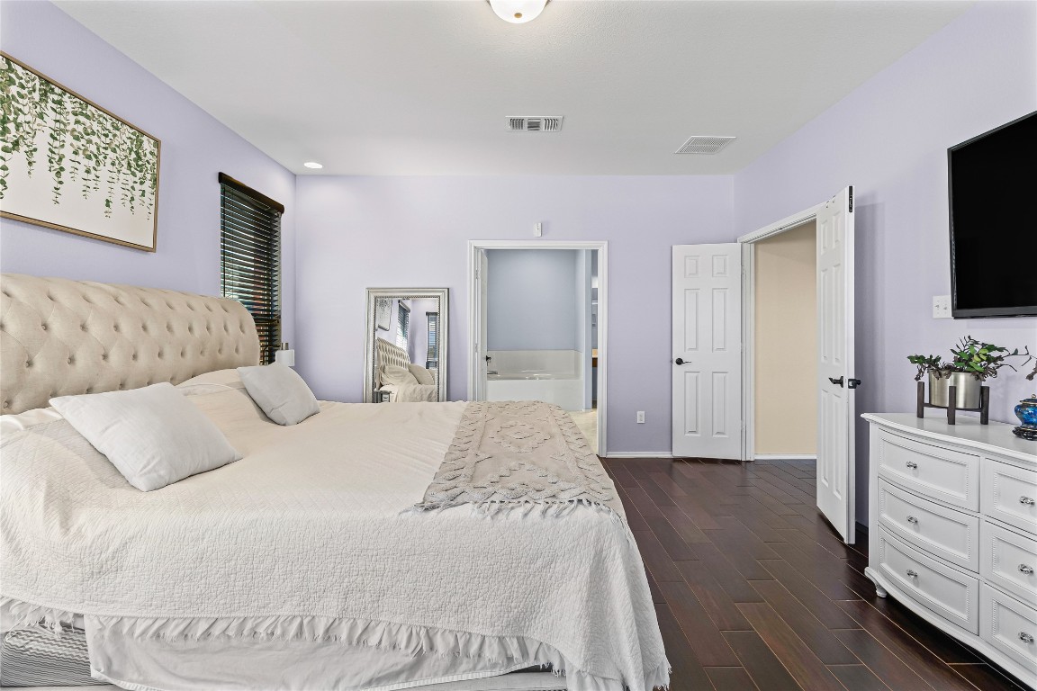 920 Autumn Sage Way Pflugerville, TX 78660 - Photo 21 of 30 a spacious bedroom with a bed and a flat screen tv in it