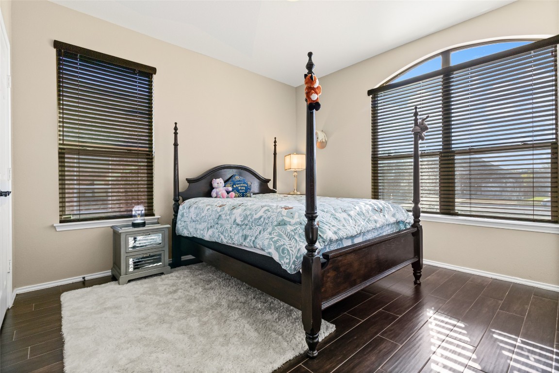 920 Autumn Sage Way Pflugerville, TX 78660 - Photo 24 of 30 a bedroom with a bed next to a large window