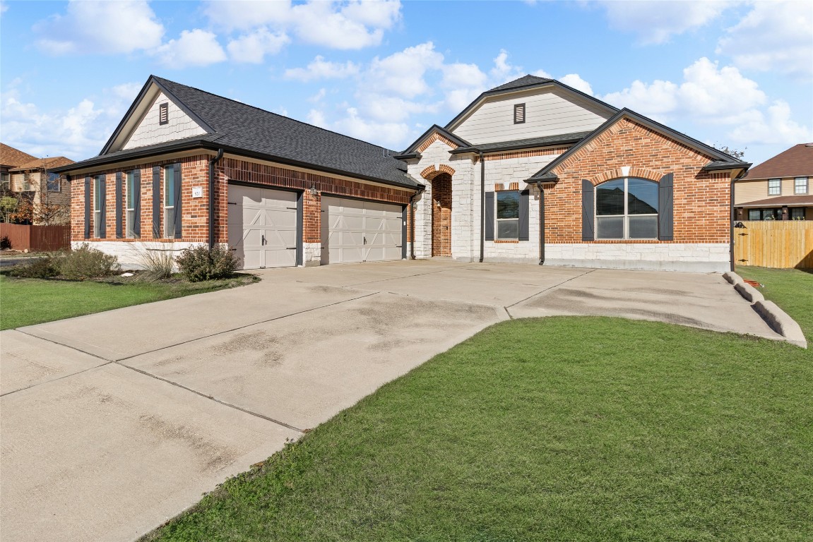 920 Autumn Sage Way Pflugerville, TX 78660 - Photo 6 of 30 a front view of a house with garden