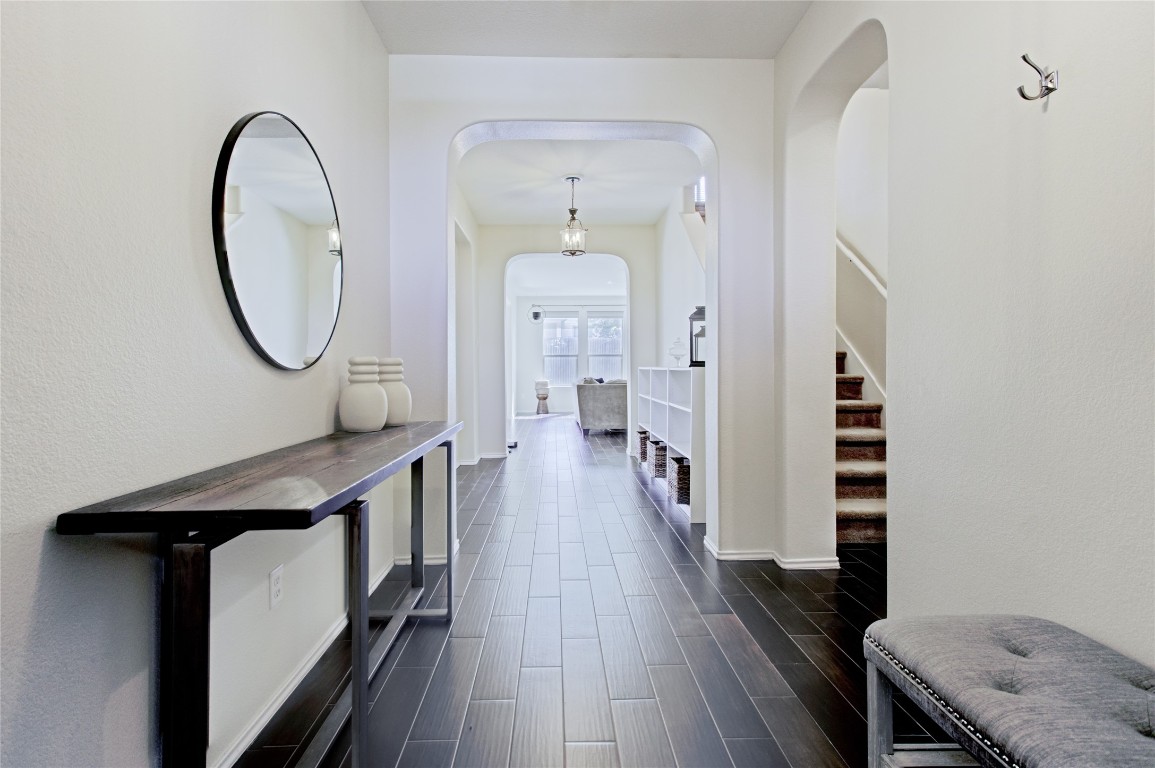 920 Autumn Sage Way Pflugerville, TX 78660 - Photo 7 of 30 a view of a hallway with wooden floor and staircase
