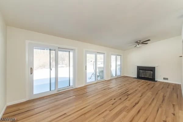 wooden floor chandelier and windows in a room